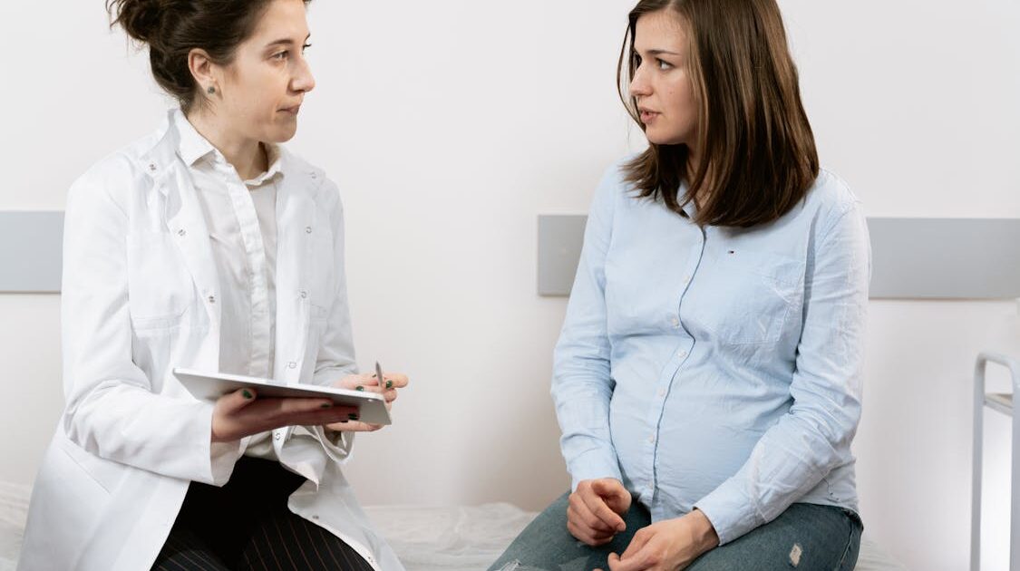 pregnant woman consulting with doctor about WIC eligibility and prenatal nutrition