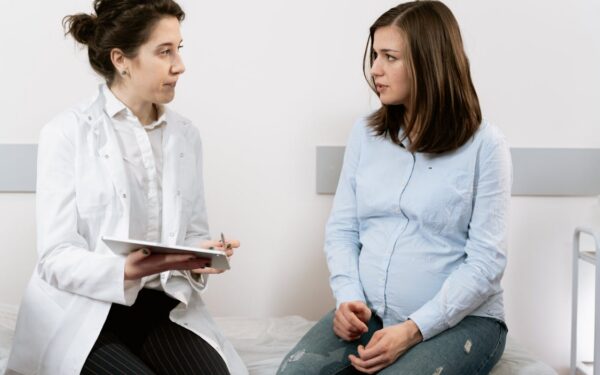 pregnant woman consulting with doctor about WIC eligibility and prenatal nutrition