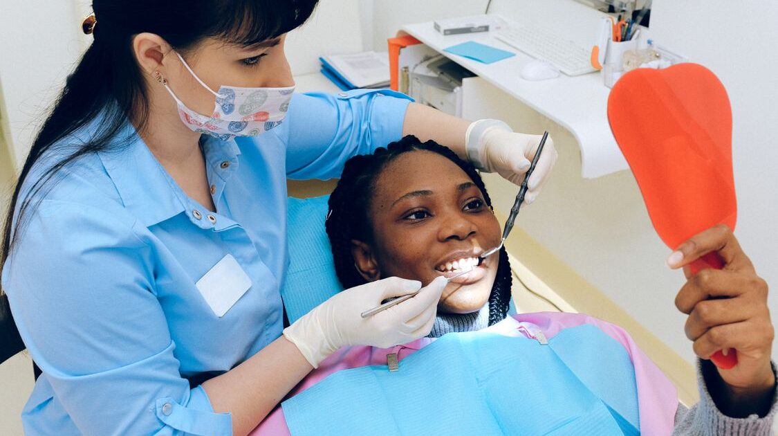 free dental care for low income adults dentist examining patient