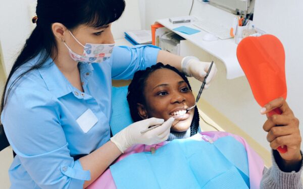 free dental care for low income adults dentist examining patient